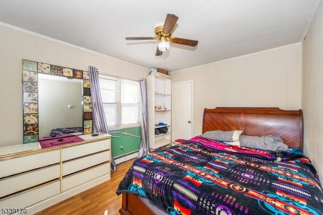 bedroom featuring a baseboard heating unit, ceiling fan, light wood finished floors, and crown molding