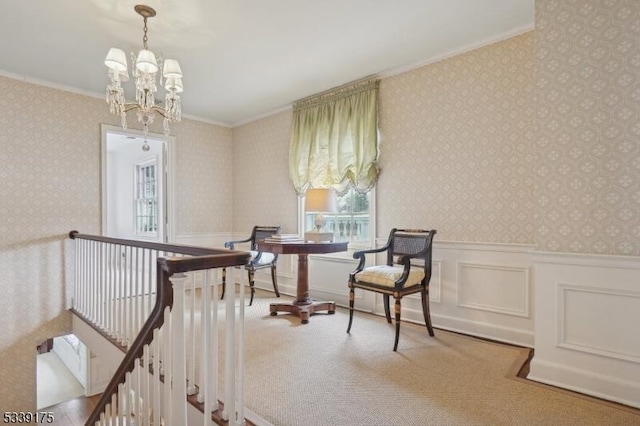 living area featuring wallpapered walls, ornamental molding, a wainscoted wall, and an upstairs landing