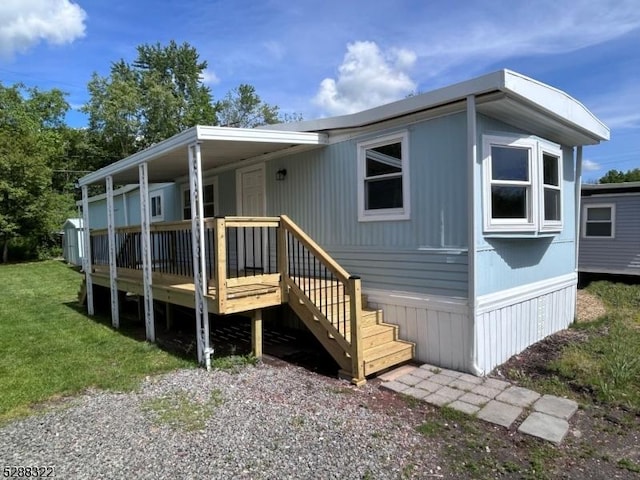 back of house with a yard and a wooden deck