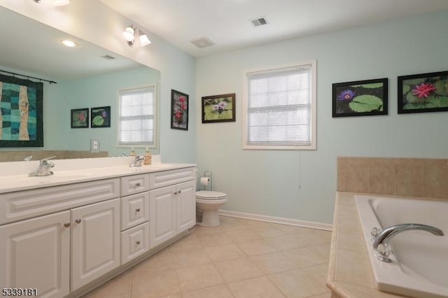 bathroom with toilet, tile patterned floors, vanity, and a relaxing tiled tub