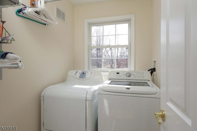 laundry area with washing machine and clothes dryer