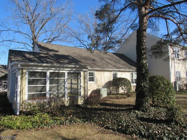 rear view of property featuring central air condition unit