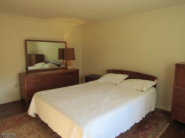 bedroom featuring dark hardwood / wood-style flooring and ornamental molding