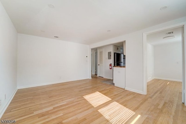 spare room featuring light hardwood / wood-style floors