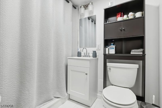 bathroom with tile patterned floors, toilet, and vanity