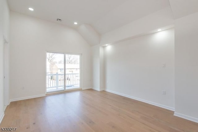 spare room featuring recessed lighting, visible vents, baseboards, vaulted ceiling, and light wood finished floors