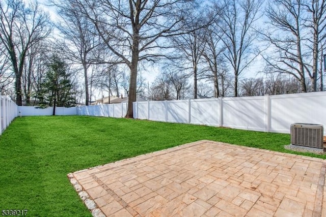 view of yard with central air condition unit, a patio area, and a fenced backyard