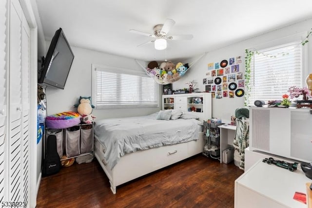 bedroom featuring multiple windows, dark wood finished floors, and a ceiling fan