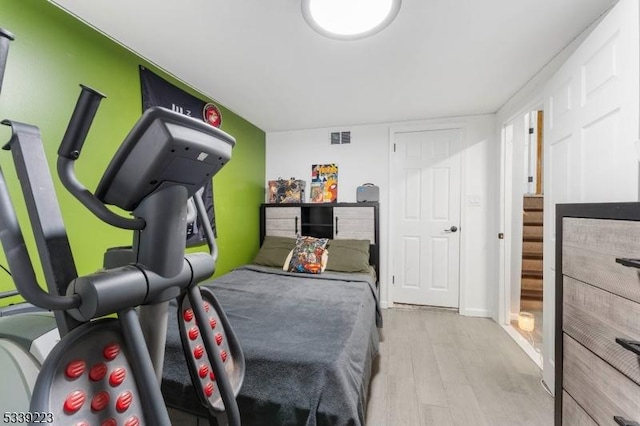 bedroom with light wood-type flooring and visible vents