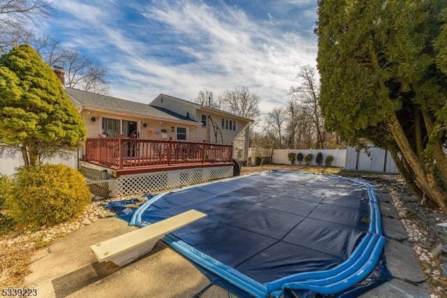 view of pool featuring fence, a fenced in pool, and a wooden deck