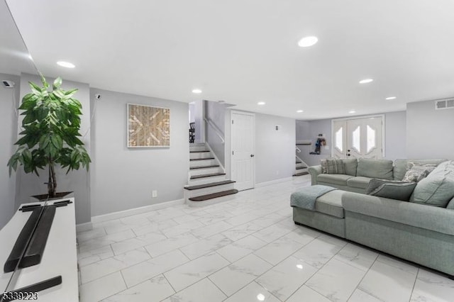 living area featuring recessed lighting, marble finish floor, and stairs