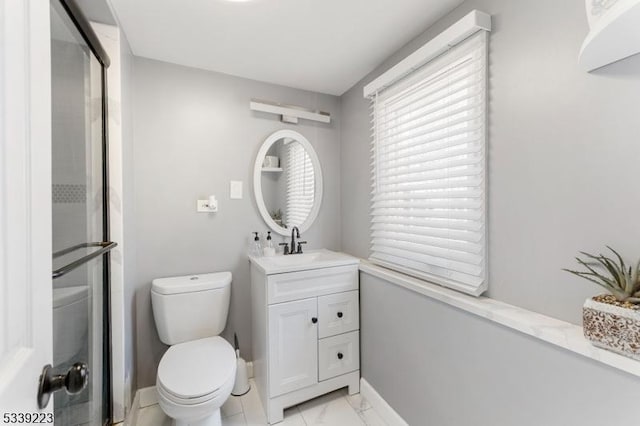 bathroom with marble finish floor, baseboards, vanity, and toilet