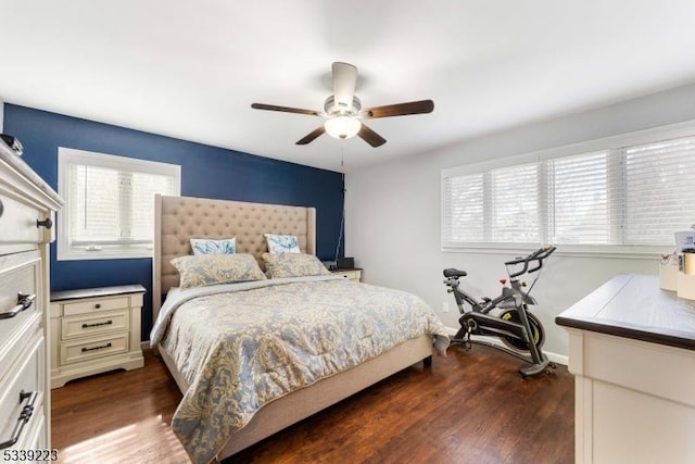 bedroom with ceiling fan, dark wood-style flooring, and baseboards