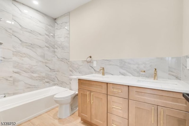 full bath featuring a sink, toilet, tile walls, and double vanity