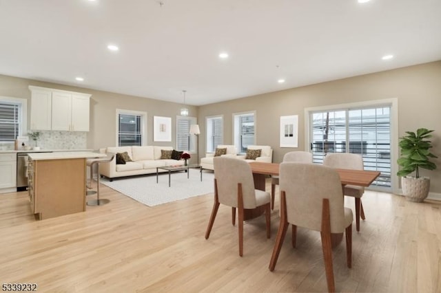 dining space featuring recessed lighting and light wood-style floors