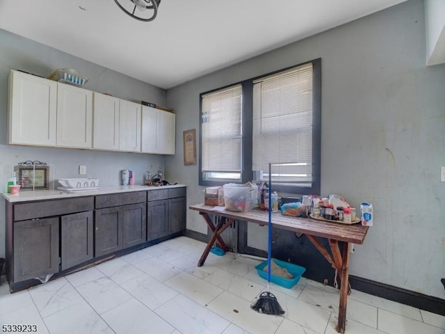 kitchen featuring dark brown cabinetry and white cabinets