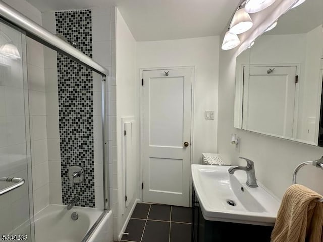 bathroom featuring vanity, bath / shower combo with glass door, and tile patterned floors