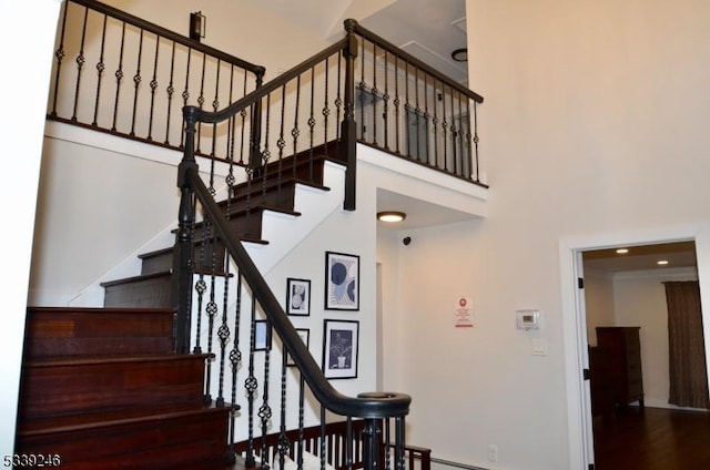 stairs featuring a towering ceiling