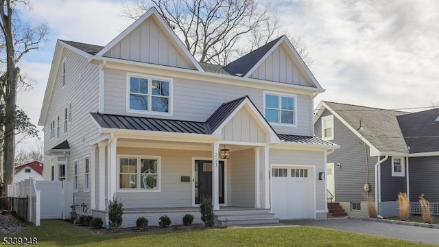 craftsman house featuring a front lawn, a porch, and a garage