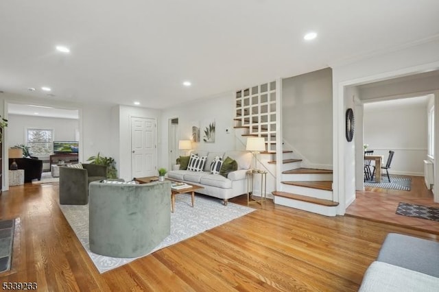 living room featuring stairway, wood finished floors, and recessed lighting