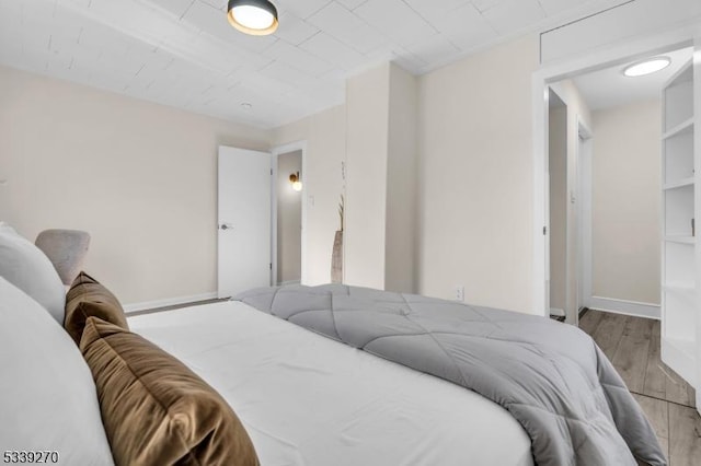 bedroom featuring light wood-type flooring and baseboards