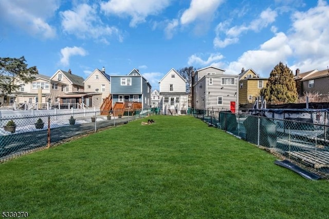 view of yard featuring fence and a residential view