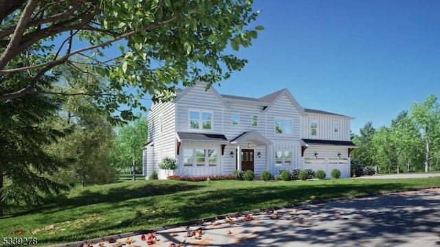 view of front of home with a garage and a front lawn