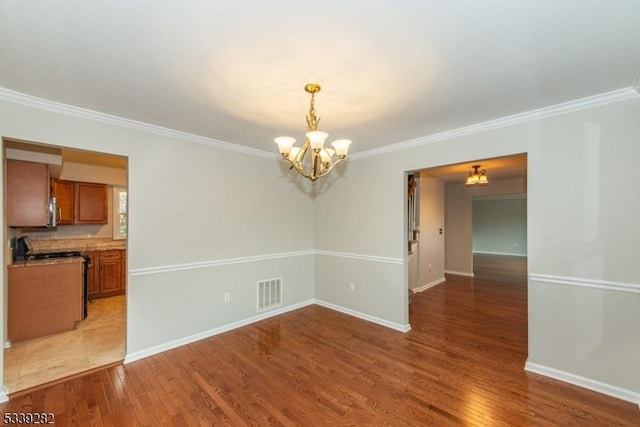 unfurnished dining area with light wood-type flooring, visible vents, and baseboards