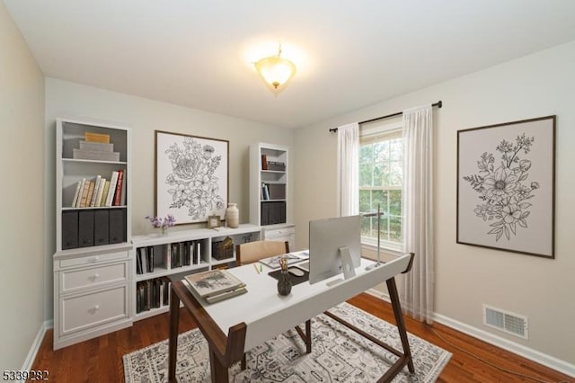 office space featuring visible vents, dark wood finished floors, and baseboards