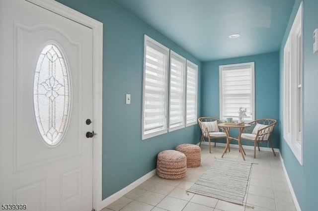 entrance foyer featuring light tile patterned floors and baseboards