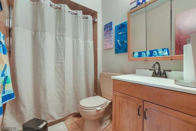 bathroom featuring curtained shower, vanity, toilet, and tile patterned floors