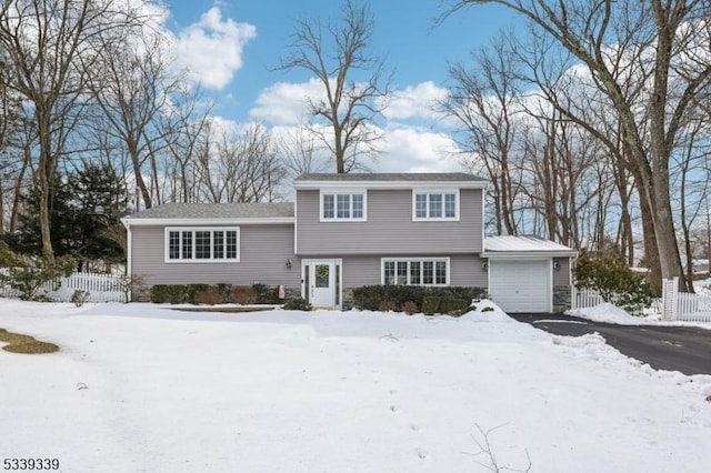 view of front of property with a garage and fence