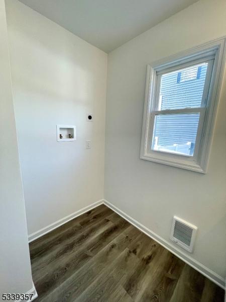 clothes washing area featuring laundry area, visible vents, dark wood-style floors, hookup for a washing machine, and electric dryer hookup