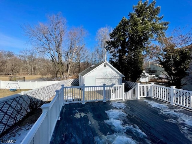 wooden terrace featuring an outbuilding and fence