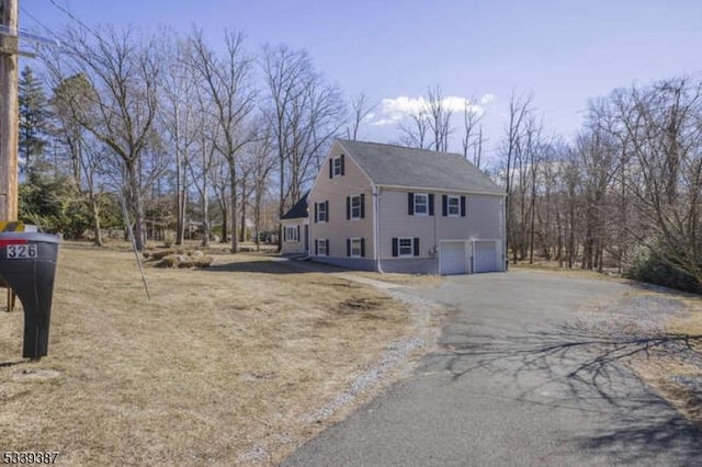 view of home's exterior featuring a garage and driveway