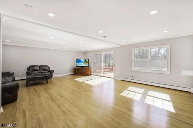 living area with recessed lighting, baseboards, baseboard heating, and wood finished floors