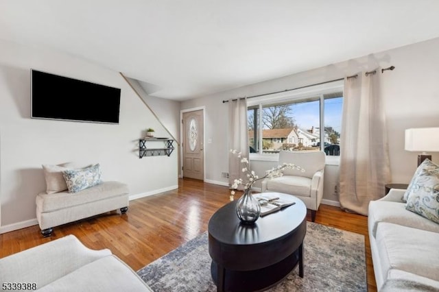 living room featuring baseboards and wood finished floors