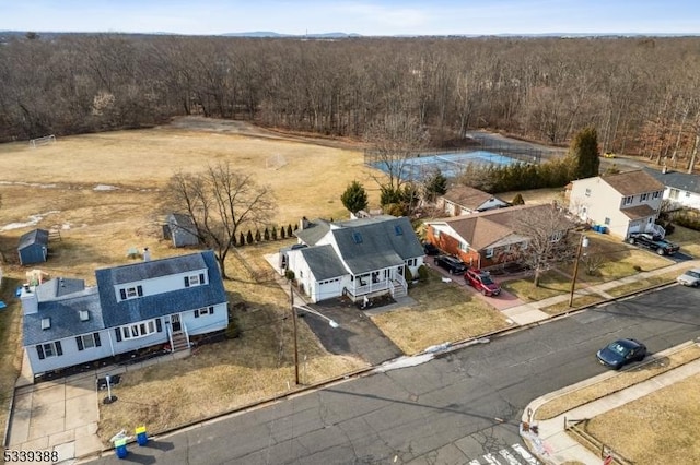 drone / aerial view featuring a wooded view