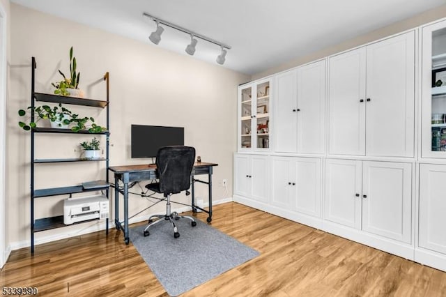 office area featuring light wood-style flooring and baseboards