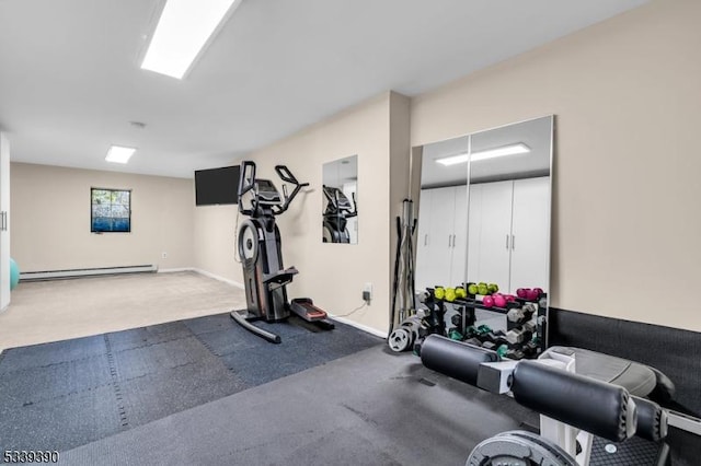 workout room featuring a baseboard heating unit, carpet floors, and baseboards