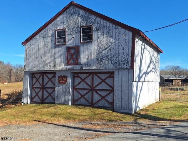 view of barn with a lawn