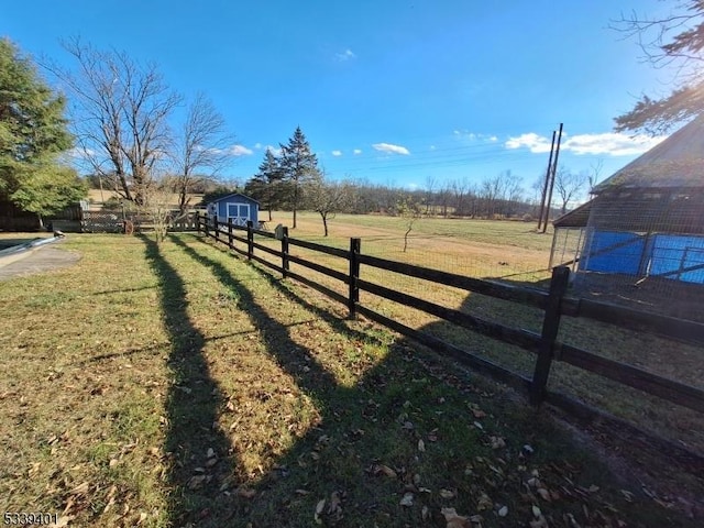 view of yard with a storage unit, an outdoor structure, and fence