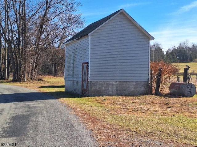 view of property exterior with an outbuilding