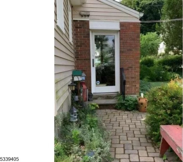 entrance to property featuring brick siding