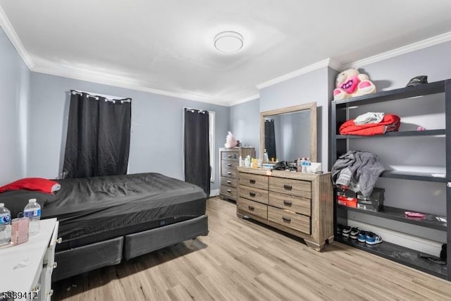 bedroom featuring light wood-style flooring and crown molding