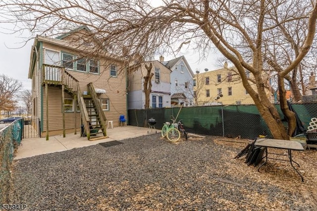 exterior space featuring a fenced backyard, stairs, and a residential view