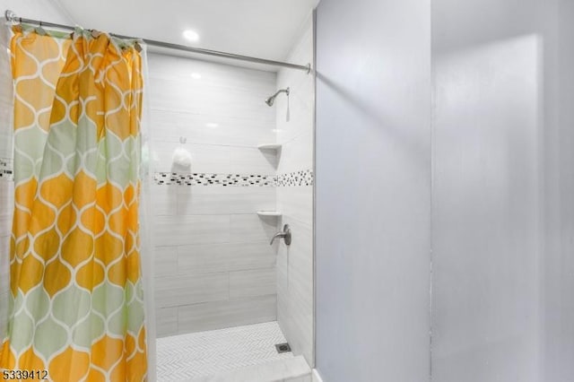 full bath with a tile shower