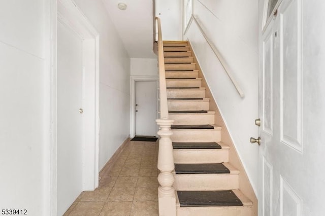 stairs featuring tile patterned floors