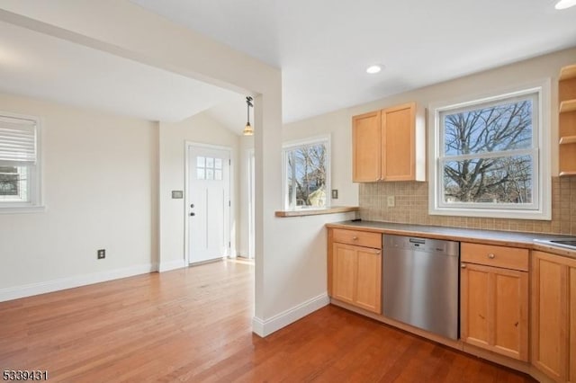 kitchen featuring light wood-type flooring, pendant lighting, dishwasher, and decorative backsplash