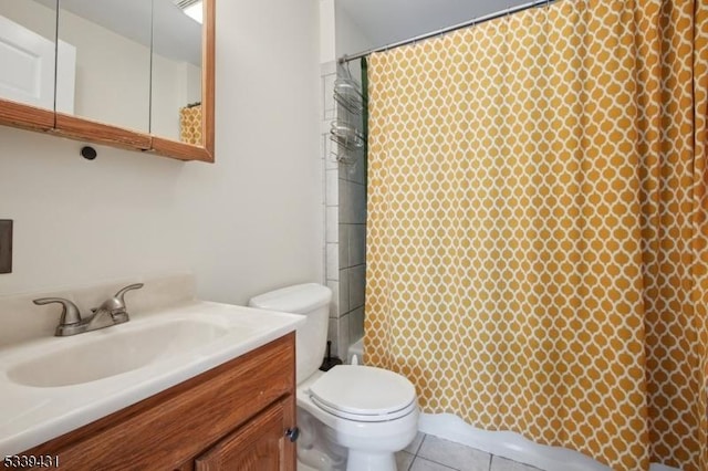 full bathroom featuring toilet, vanity, and tile patterned floors